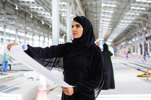 istock Abu Dhabi Design Professional Examining Blueprint Onsite 1198872686