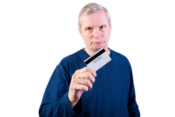 istock An elderly man shows a credit card. Isolated on a white background. 1198876949