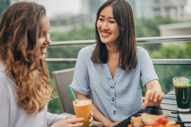 istock Two cheerful women having fun in a cafe 1198881197