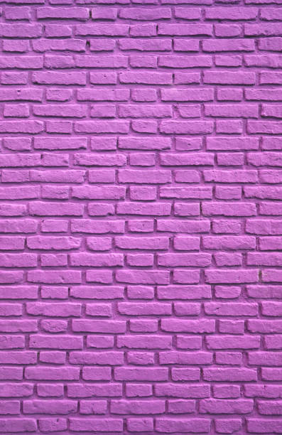 istock Vertical Image of Purple Pink Colored Aging Brick Wall 1198882677