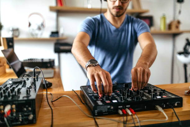 istock Dj working on sound mixer at home recording studio 1198883957