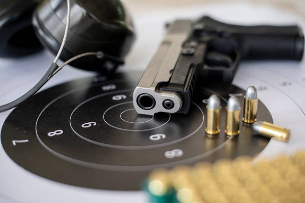 istock Guns with ammunition on paper target shooting   practice 1198884742