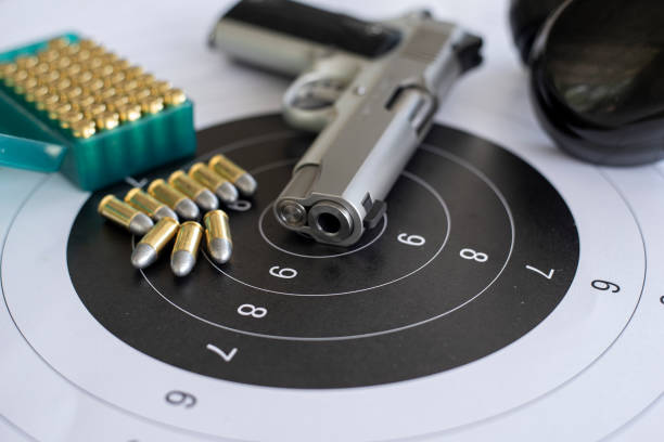 Guns with ammunition on paper target shooting   practice