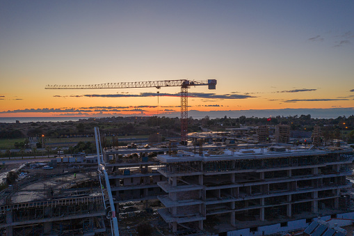 Construction site at dusk evening silhouette cranes