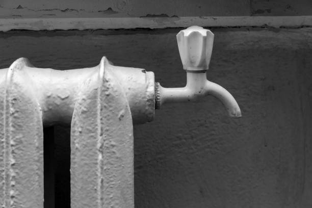 Faucet on an old cast-iron radiator for indoor heating. Vintage steam heating battery