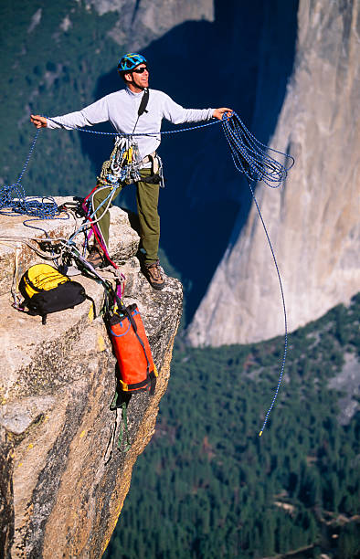 istock Rock climbing team reaching the summit. 119889393