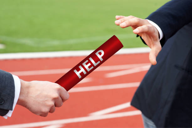 istock Give or accept help - Passing the baton in the stadium - Closeup 1198896909