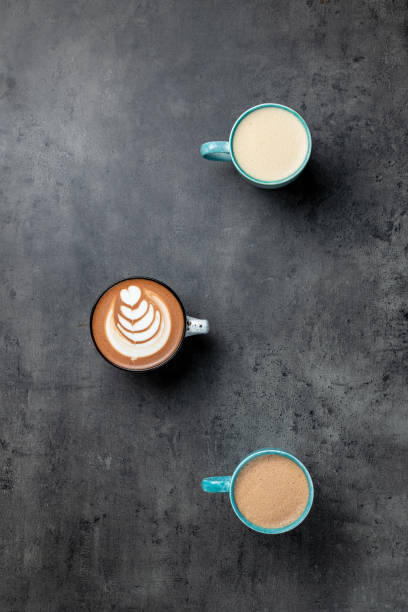 istock 3 cups of coffee on grey background with negative space top view 1198898748