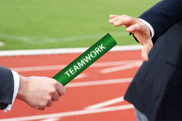 Teamwork - Cropped Hands of Businessman Passing Relay Baton