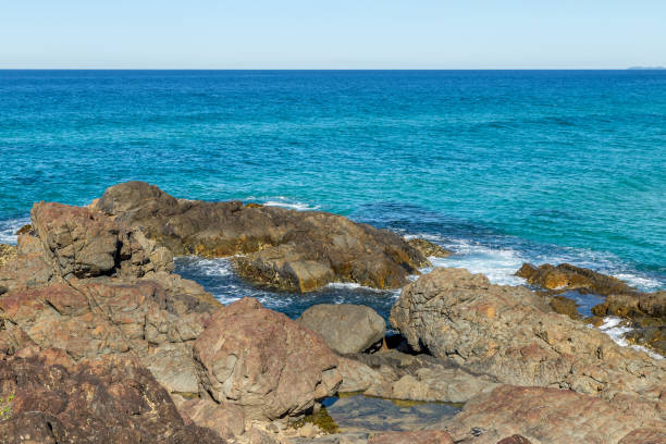 istock Small rockpools created in rocky shoreline 1198899608