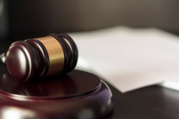 istock Judge's gavel with white paper on the background 1198901133