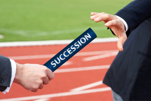 istock Business Person passing Succession baton 1198901175