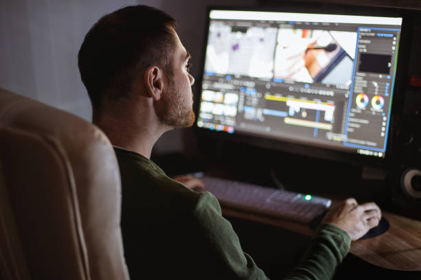 istock Video montager mounts video at desktop. Home workstation 1198906211