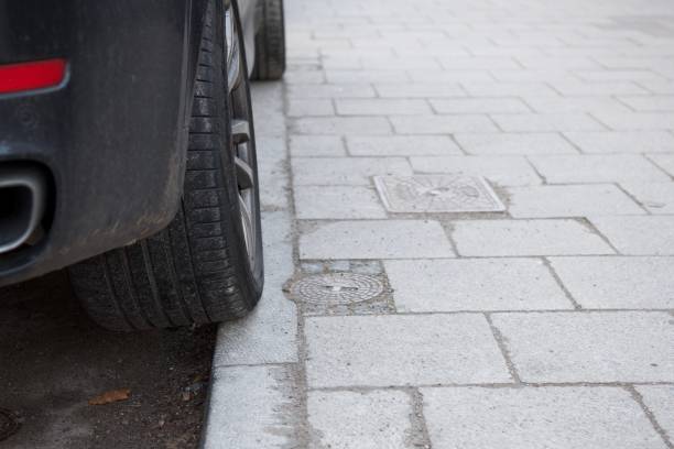 A SUV with tyres on the sidewalk