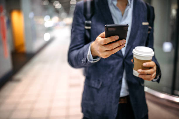 istock Businessman Using Mobile Phone In Subway Station 1198910418