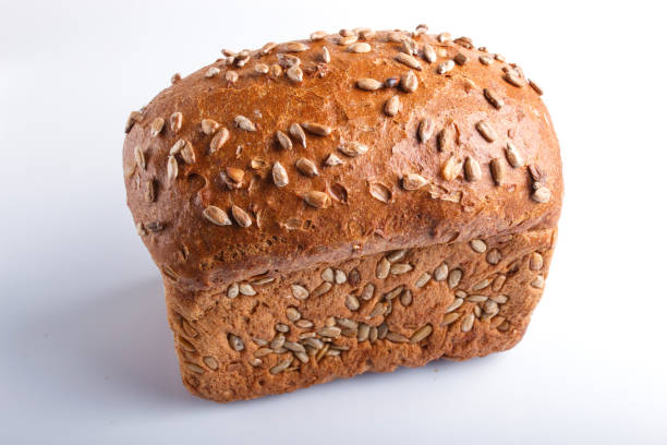 istock Rye bread with sunflower seeds isolated on white background. close up. 1198913182