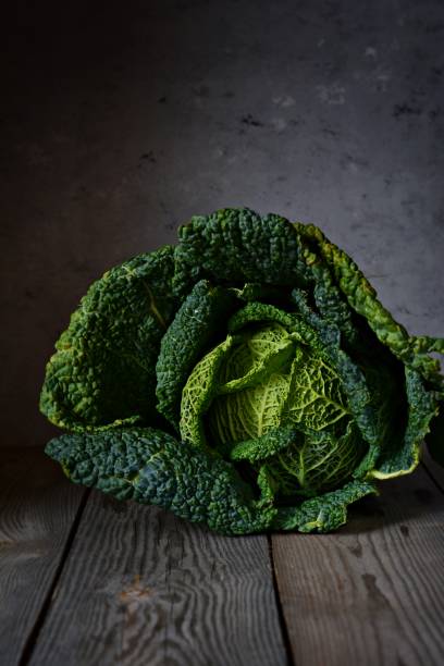 istock Green savoy cabbage on a dark background closeup. Healthy vegetable. 1198916315