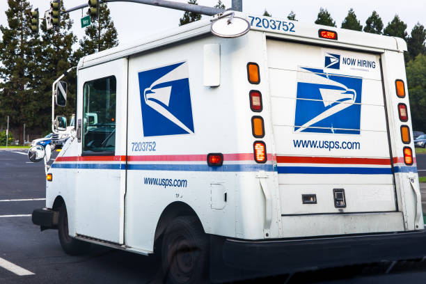 USPS vehicle waiting at a stop sign Dec 20, 2019 Sunnyvale / CA / USA - USPS vehicle waiting at a stop sign united states postal service photos stock pictures, royalty-free photos & images