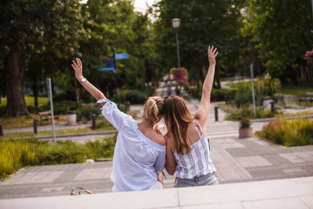istock Girlfriends having fun while relaxing outdoors and enjoying coffee together 1198926256
