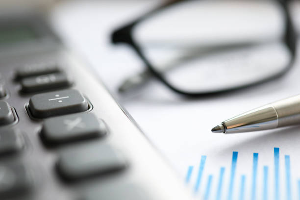 istock Silver pen with paper chart and glasses lie in office table 1198926305