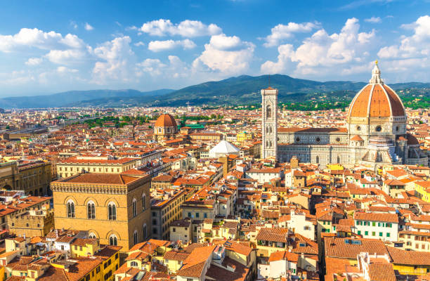 top aerial panoramic view of florence city with duomo cattedrale di santa maria del fiore cathedral, buildings houses with orange red tiled roofs and hills range, blue sky white clouds, tuscany, italy - roof tile architectural detail architecture and buildings built structure imagens e fotografias de stock