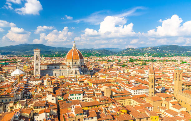 top aerial panoramic view of florence city with duomo cattedrale di santa maria del fiore cathedral, buildings houses with orange red tiled roofs and hills range, blue sky white clouds, tuscany, italy - roof tile architectural detail architecture and buildings built structure imagens e fotografias de stock