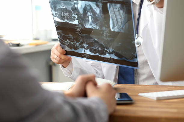 istock Surgeon holding spine x-ray 1198926540
