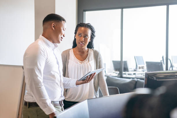 istock Male manager with table explaining to female employee 1198926830
