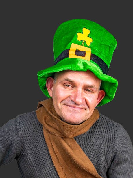 istock St. Patrick in a green top hat with clover. 1198927383