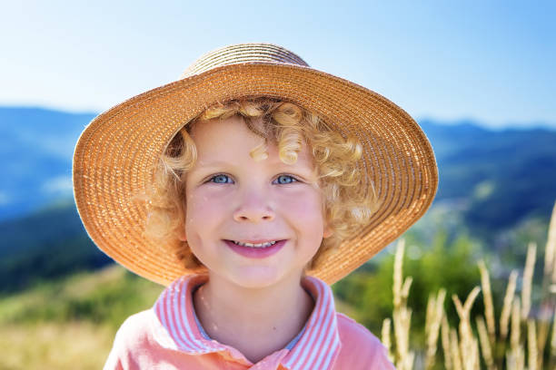 boy in a straw hat in summer
