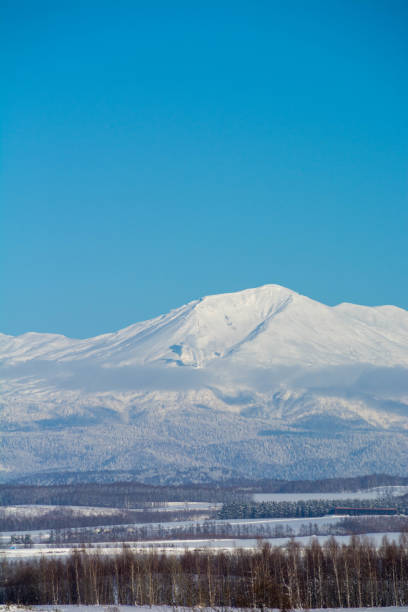 istock Snowy mountain peaks and blue sky,Mt.Daisetuzan 1198934211