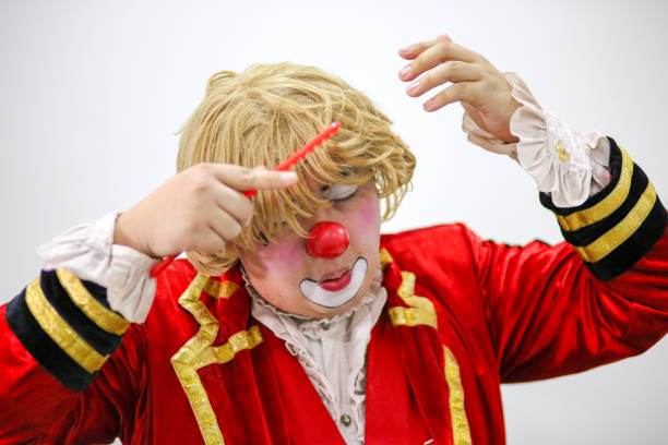Portrait of a clown performer - using comb to comb his wig neatly.
