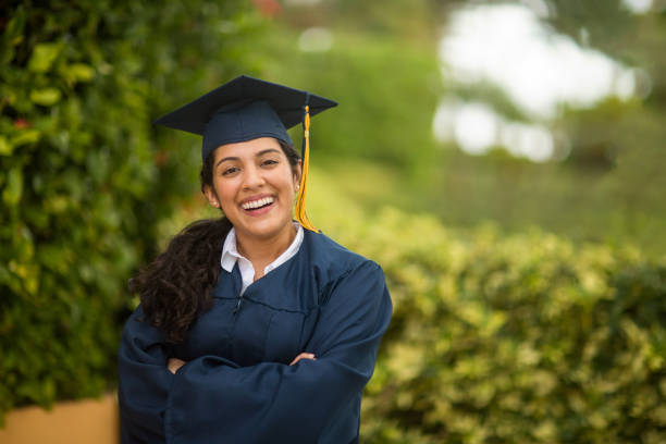 Young Hispanic woman graduating Happy young Hispanic woman graduating. mortarboard photos stock pictures, royalty-free photos & images