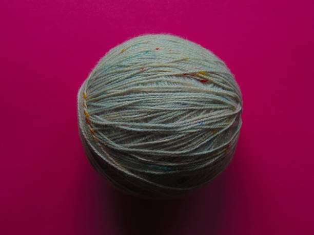 istock A ball of thread on a pink background 1198952134