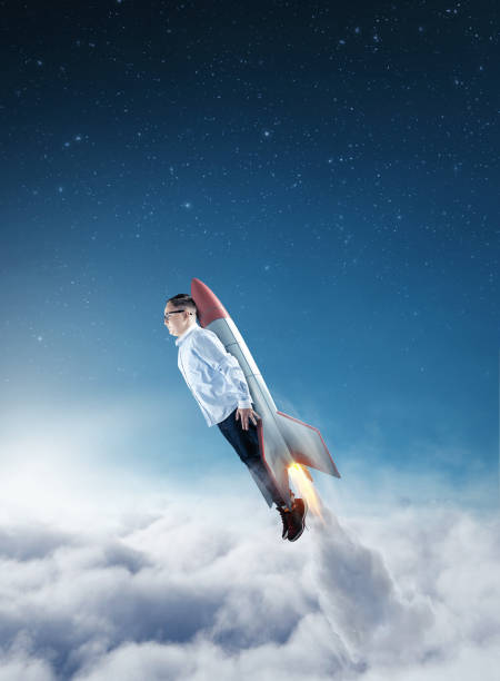 istock Young businessman flying above clouds with a rocket. Launch start up business concept. 1198952202