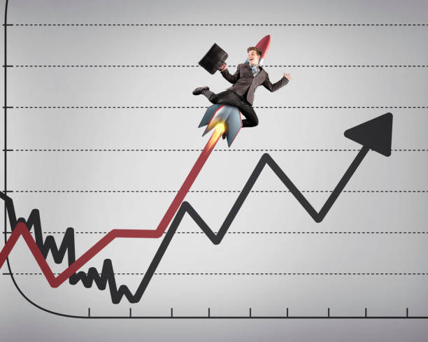 istock Businessman flying up over a graph with a rocket. 1198952233