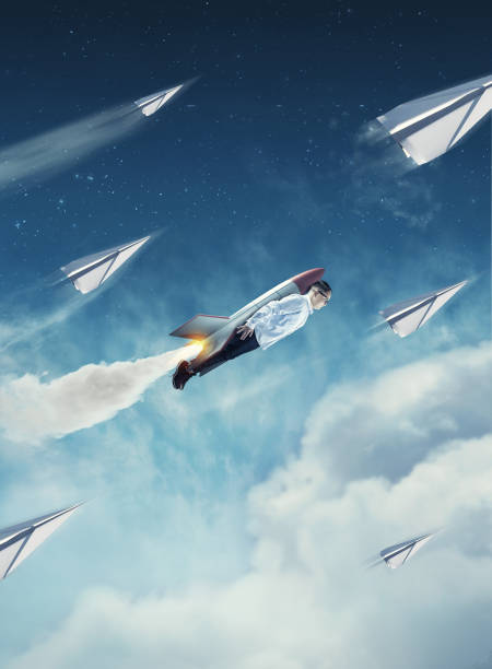istock Young man flying with a rocket and paper airplanes. 1198952766