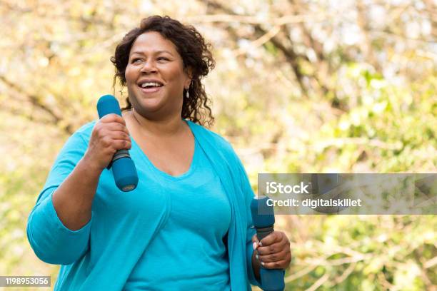 Mature African American Woman Smiling And Exercising Stock Photo - Download Image Now