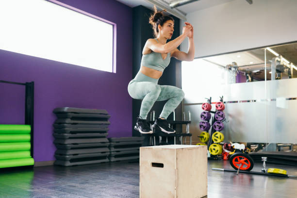 istock Caucasian female doing box jump workout at gym. 1198957273