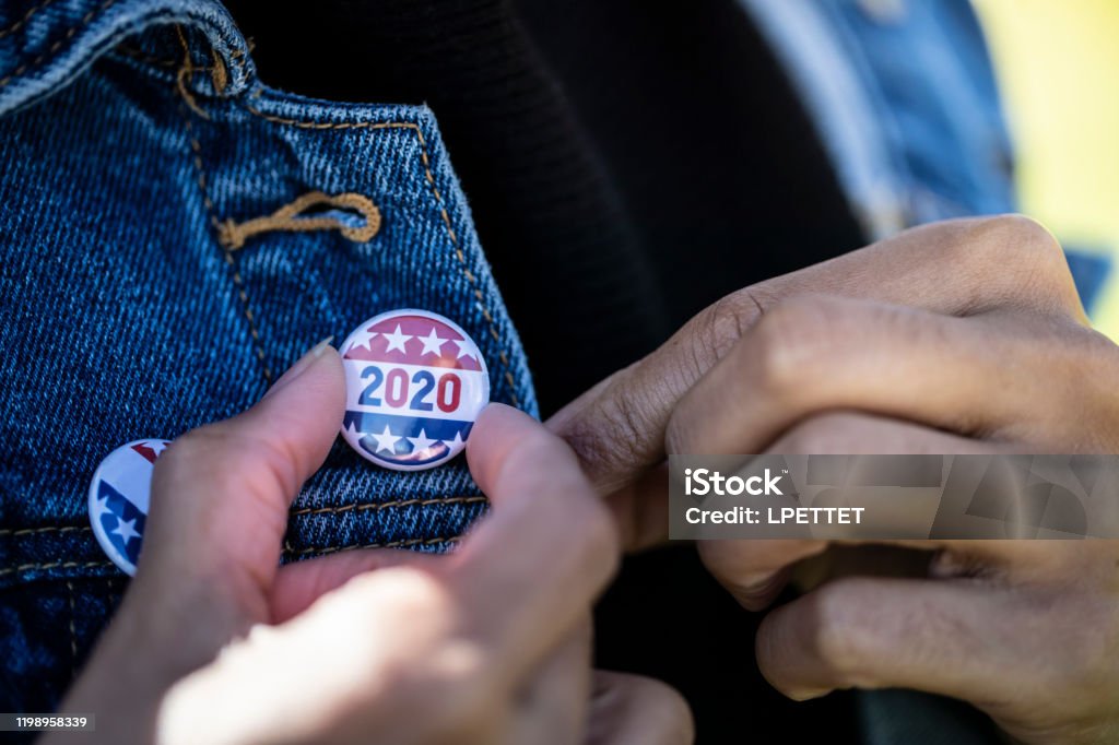 Voting A young African American woman holding a voting badge. Voting Stock Photo