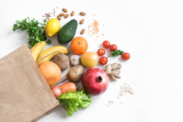 Organic vegan food Healthy food background. Healthy vegan vegetarian food in paper bag vegetables and fruits on white, copy space. Shopping food supermarket and clean vegan eating concept. vegan food photos stock pictures, royalty-free photos & images