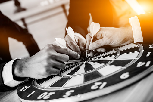 Business successful and goal concept with dart board game. Businessman with team for teamwork.