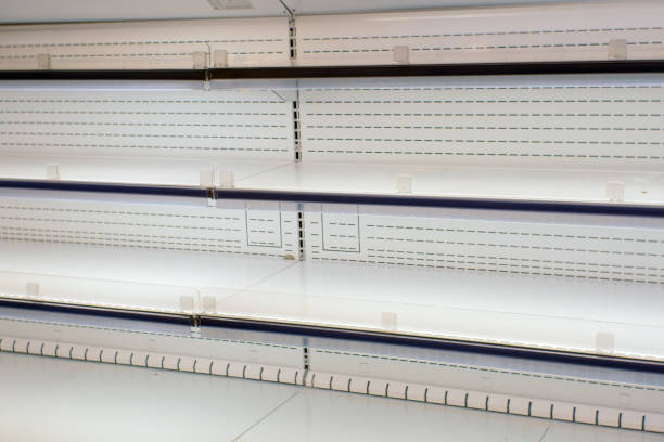 istock empty white shelves in a store, supermarket 1198971543