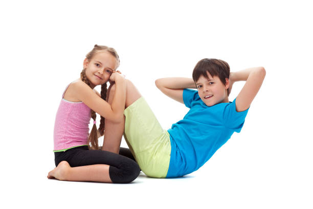 istock Kids doing gymnastic exercises together - helping each other 1198972640
