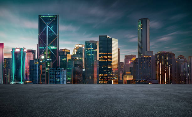 istock empty asphalt road with beautiful night cityscape scene . 1198973726