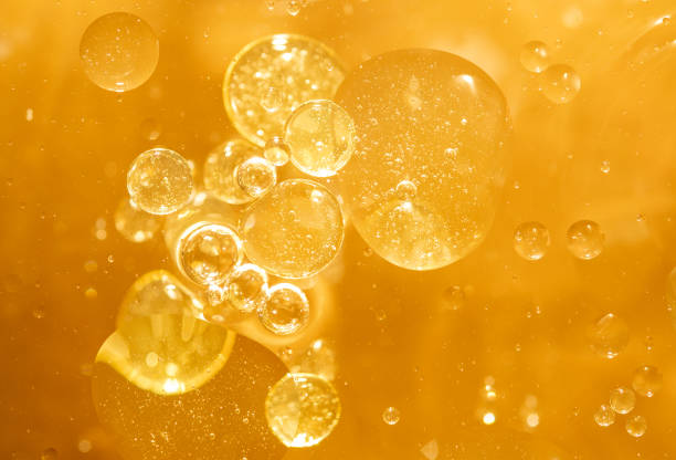 istock golden yellow bubble oil droplet, abstract background 1198976004