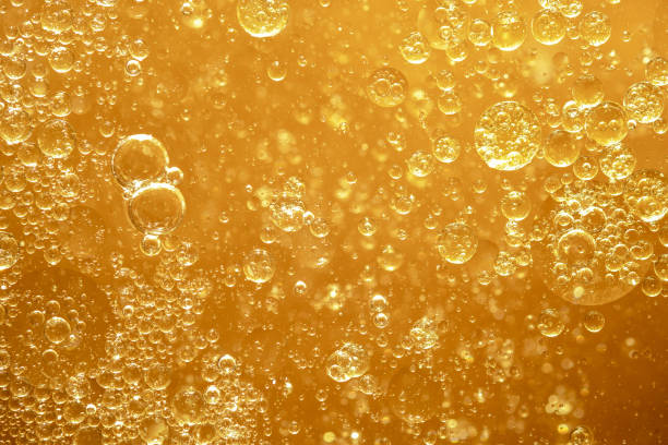 istock golden yellow bubble oil droplet, abstract background 1198976009