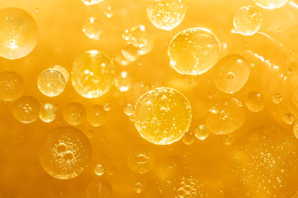 istock golden yellow bubble oil droplet, abstract background 1198976014