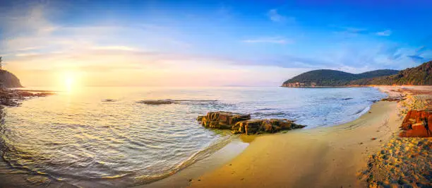 Photo of Sunset in Cala Violina bay beach in Maremma, Tuscany. Mediterranean sea. Italy.