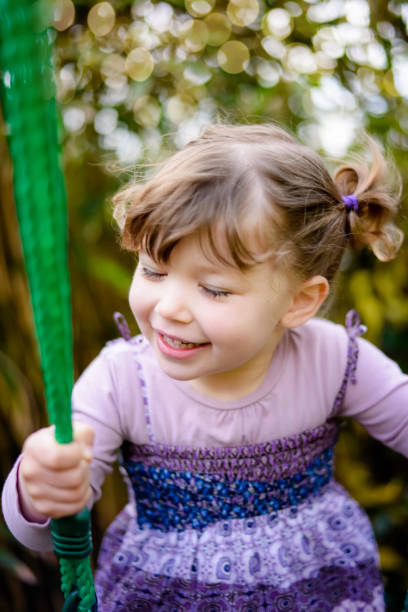 istock pretty little girl on her swing 1198977887